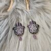 IMG20260831152516 Hamsa-korvakorut, musta /violetti metallinhohto